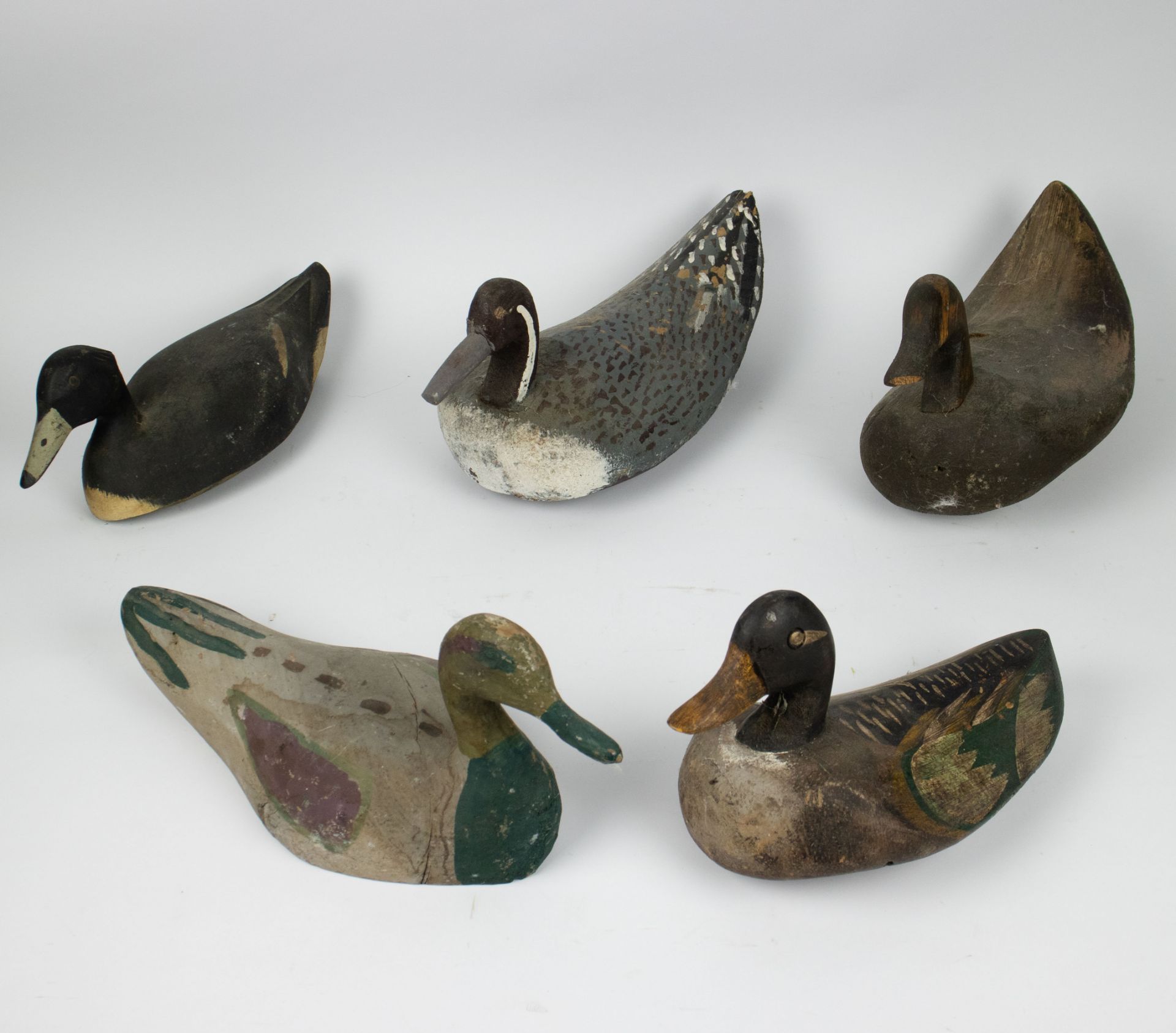 A collection of 5 wooden decoy ducks