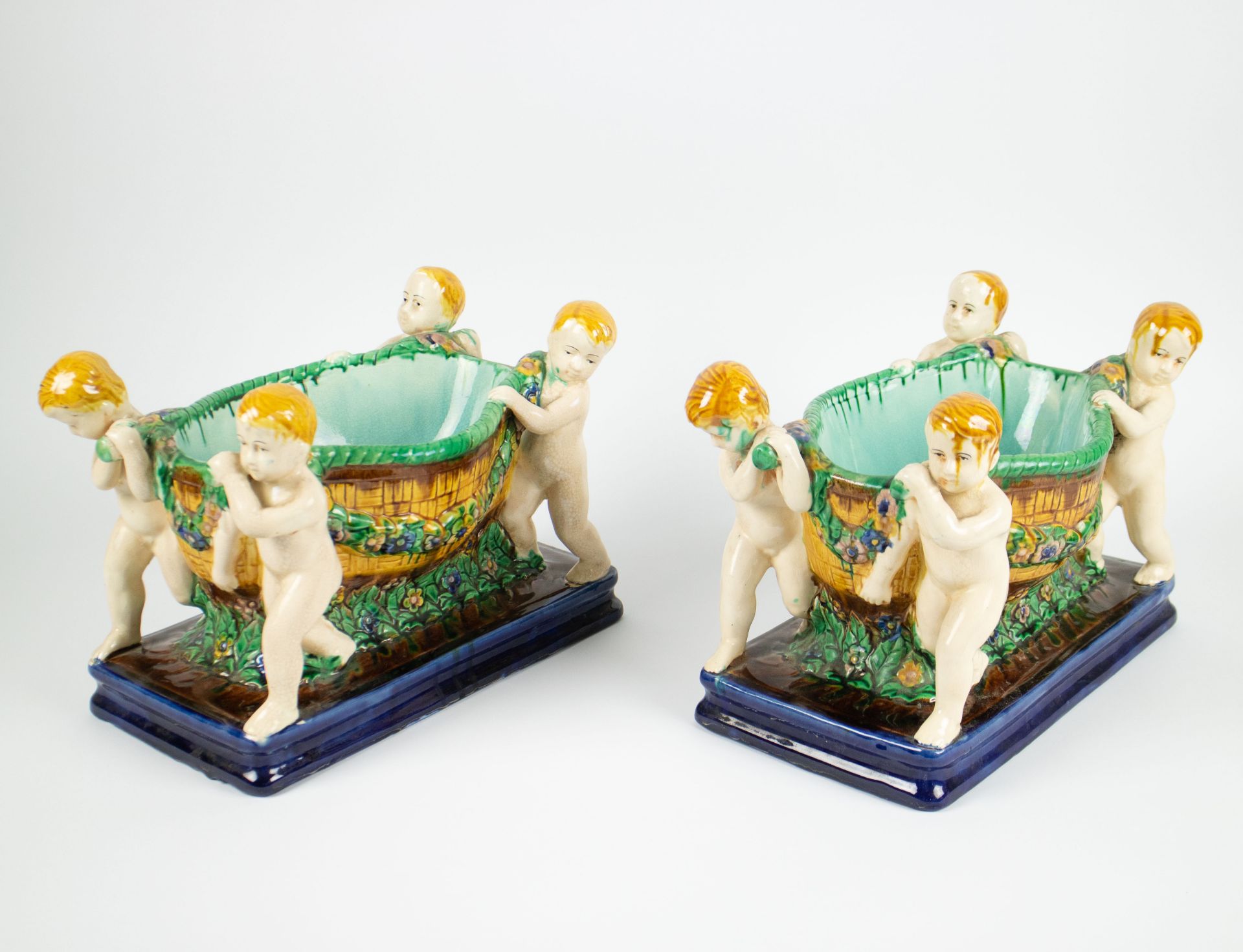Pair of Austrian earthenware bowls carried by Cupids, around 1900