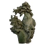 Large bowenite (serpentinite species) sculpture of a carp among birds and prunus blossom