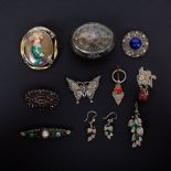 A collection of brooches and earrings