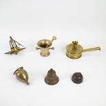 A collection of a holy water font, oil lamp, candle holder, 2 bells and mortar