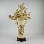 A large Chinese flower arrangement with peonies, chrysanthemums and magnolias