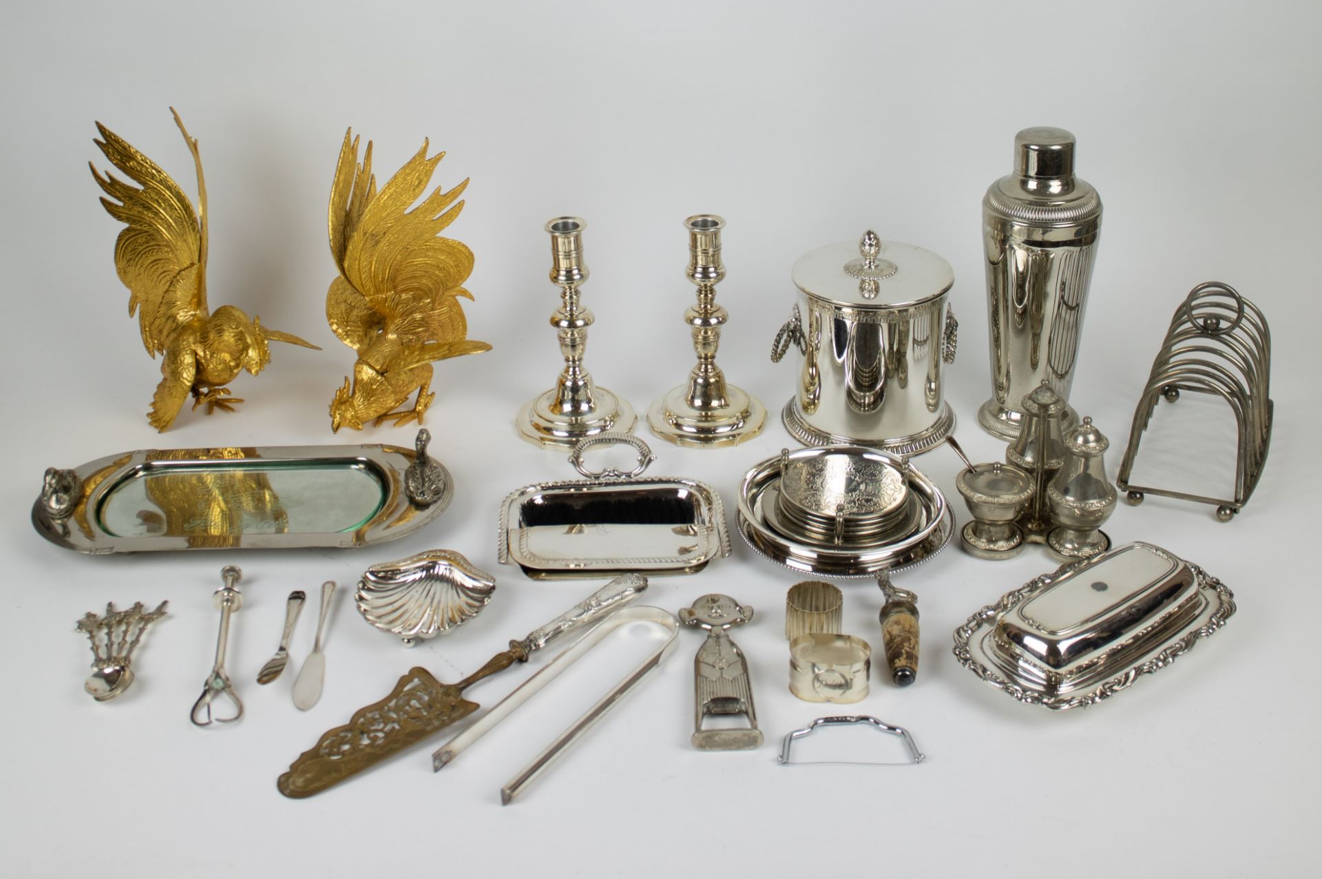 A large collection of silver plated items, including a foi gras dish, a wine bottle holder and more