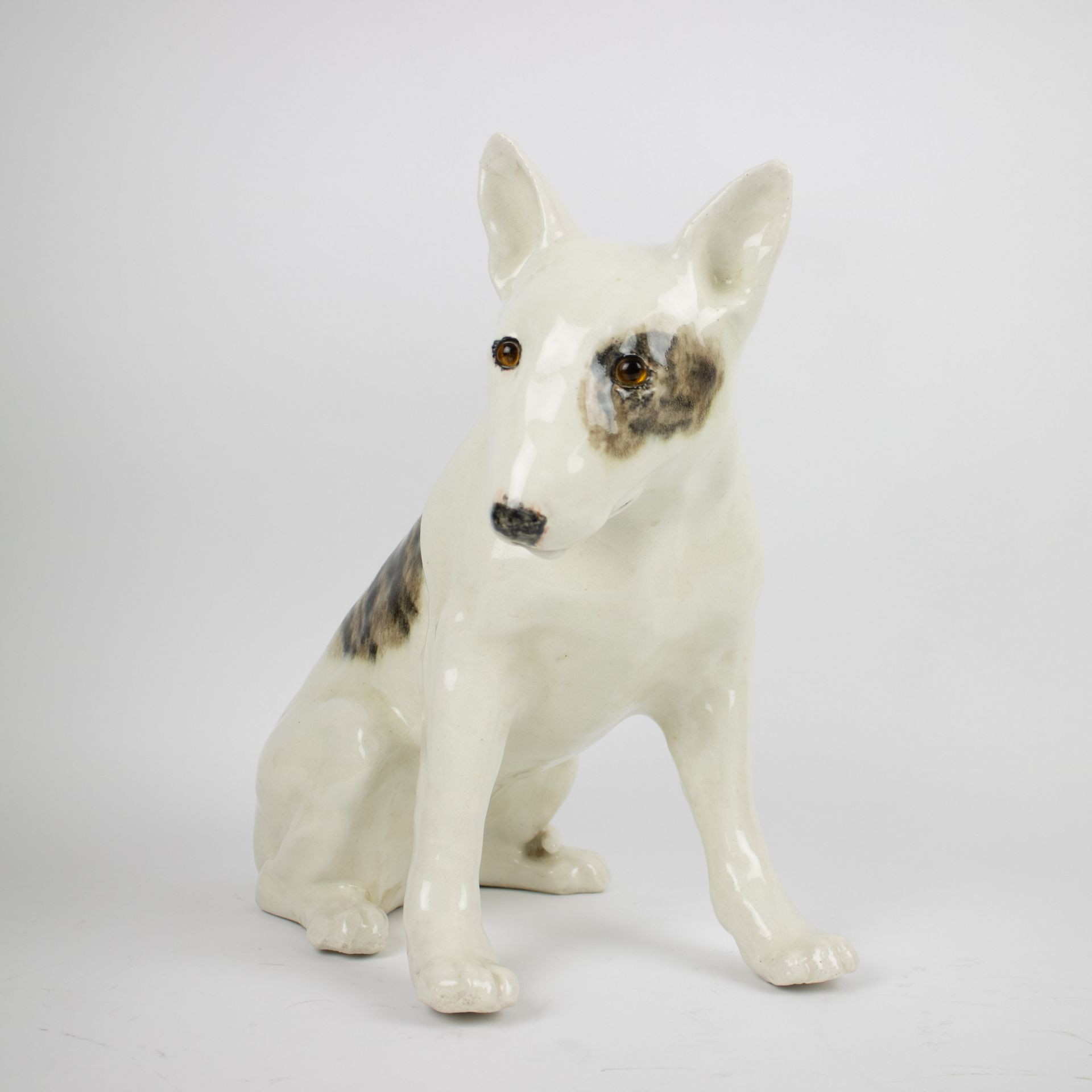 A glazed porcelain sculpture of a dog English.