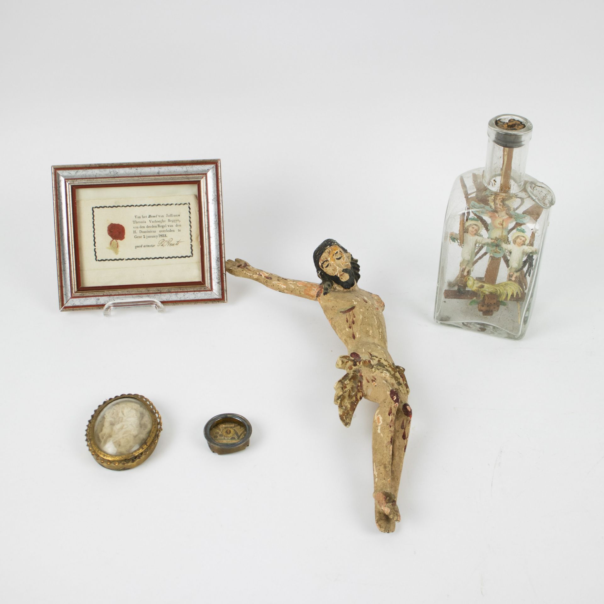 A collection of religious items consisting of a relic, a relic beguine Theressia Verhaeghe, a bottle