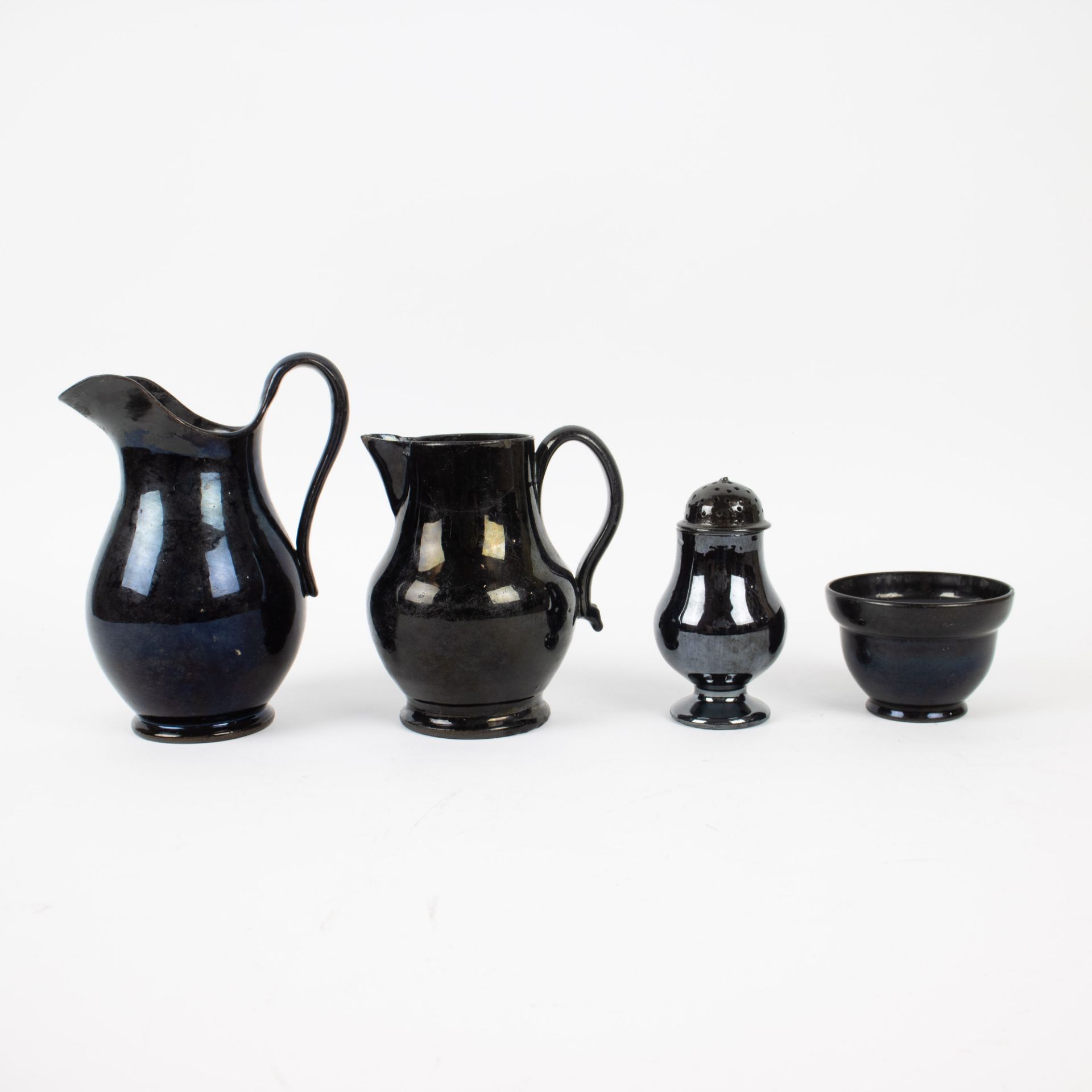 A collection of black glazed jugs, butter pot and salt cellar in Namur earthenware, 18th century