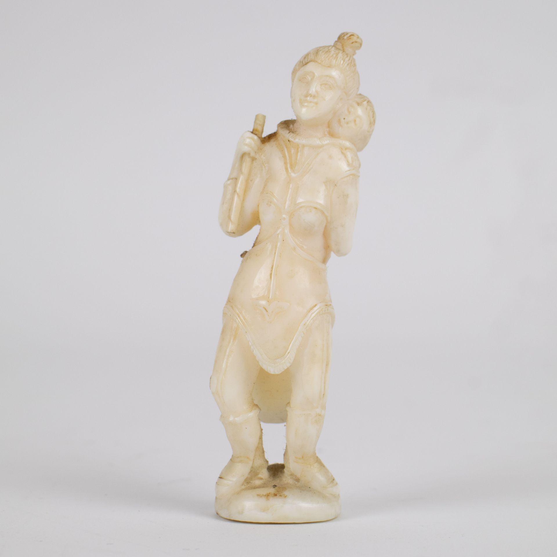 Marine ivory sculpture of a woman carrying a child on her back, Greenland, early 20th century.
