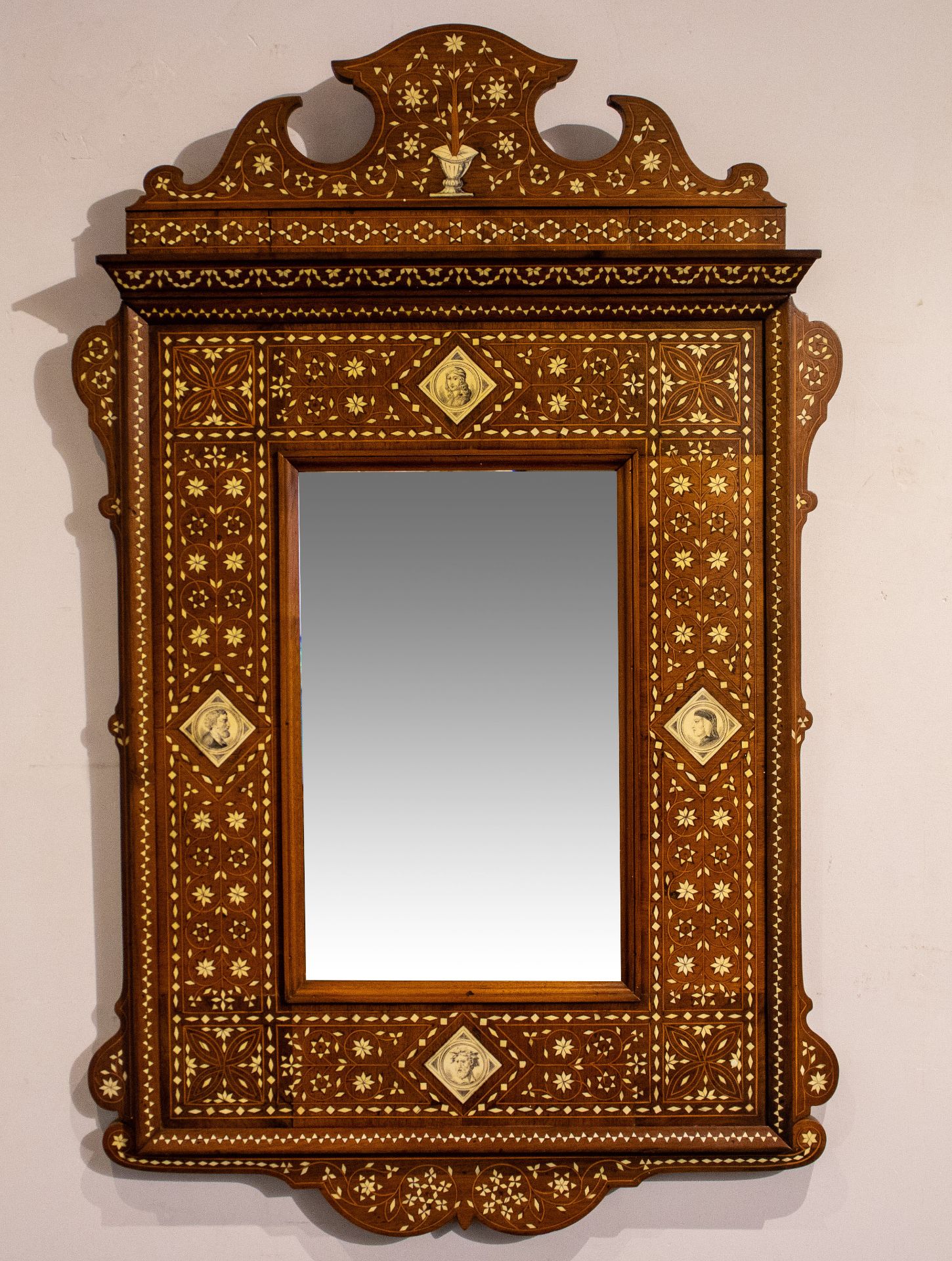 Wooden mirror with bone marquetry and four medaillons