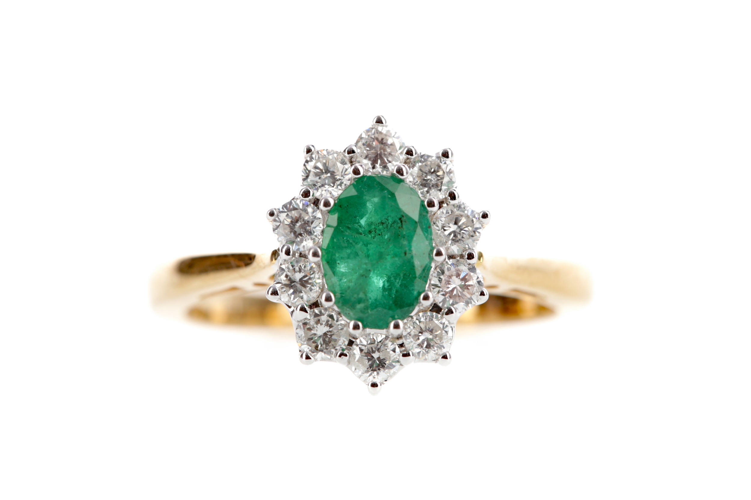 AN EMERALD AND DIAMOND CLUSTER RING