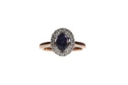 A SAPPHIRE AND DIAMOND CLUSTER RING