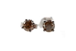 A PAIR OF COGNAC DIAMOND STUD EARRINGS