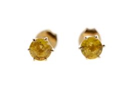 A PAIR OF TREATED YELLOW SAPPHIRE STUD EARRINGS