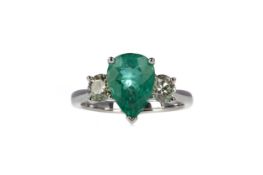 AN EMERALD AND DIAMOND THREE STONE RING