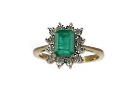 AN EMERALD AND DIAMOND CLUSTER RING