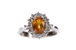 AN ORANGE SAPPHIRE AND DIAMOND RING