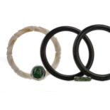 THREE JADE BANGLES AND TWO RINGS