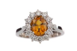 AN ORANGE SAPPHIRE AND DIAMOND RING