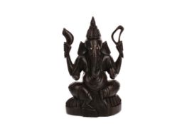 AN EASTERN CARVED HARDWOOD FIGURE OF GANESHA