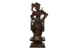 A BALINESE CARVED WOOD FIGURE
