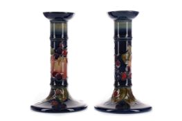 A PAIR OF MOORCROFT 'BIRDS & BERRIES' PATTERN CANDLESTICKS