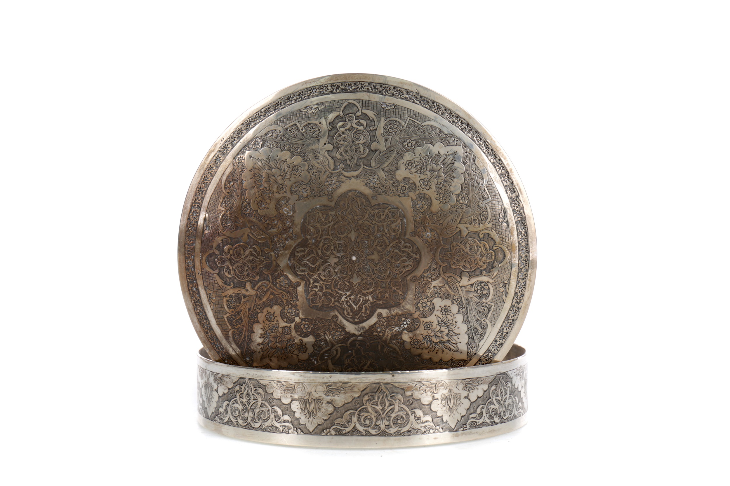 A MIDDLE EASTERN WHITE METAL CIRCULAR LIDDED BOX