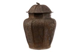 A MIDDLE EASTERN BRONZED METAL OCTAGONAL CANISTER