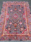 A PERSIAN HAND KNOTTED WOOL CARPET