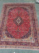 A PERSIAN HAND KNOTTED WOOL CARPET