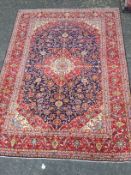 A PERSIAN HAND KNOTTED WOOL CARPET