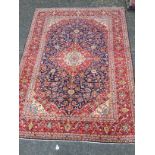 A PERSIAN HAND KNOTTED WOOL CARPET