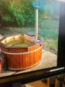 Brand new 1.9 m spruce hot tub with stainless log heater. chimney benches safety gate