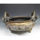 A 19th century large bronze Censer with elaborate dragon handles, dragons in relief to the squat