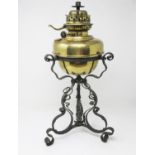 A brass Paraffin Lamp on wrought iron base of scroll design