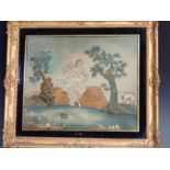 A framed Georgian Needlework Panel depicting young girl beside a pond and tree with sheep, with