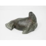 An Inuit carved stone sculpture of a Walrus, scratch signed 'Jimmy' to underside 6 1/2in L