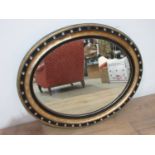 A George III Irish oval Wall Mirror with ebonised and gilt frame inset with cut glass studs, two