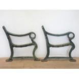 A pair of cast metal garden bench ends