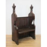 A Victorian oak Pew of narrow proportions with high sides terminated with leafage surmount 4ft 8in H