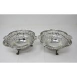 A pair of George V silver pierced circular Bowls with leafage friezes on winged paw feet, Birmingham