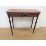 A Regency mahogany Tea Table with reeded D-shape fold-over top above lozenge inlaid frieze on ring-