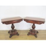 A pair of 19th Century carved mahogany Card Tables, the foldover tops above shaped friezes on