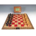 A Staunton Chess Set by Jaques & Son, London with boxwood and ebonised pieces and including Moroccan