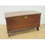 A small 18th Century elm Blanket Chest with hinged cover enclosing a candle box, and raised on