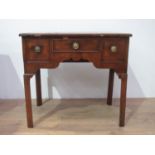 A Georgian walnut Lowboy fitted three drawers with a quarter veneered and crossbanded top, fitted