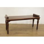 A 19th Century mahogany Hall Bench with moulded blocks above a rectangular seat raised on taper