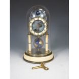 A Kaiser Universe moon phase torsion Clock with circular dial, globe pendulum under glass dome, 10