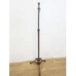 An Arts & Crafts Standard Lamp with brass telescopic column on wrought iron tripod base, centred