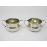 A pair of George V silver two-handled Bowls of bellied form with hammered design, Chester 1916,