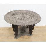 An unusual 19th Century Indian Table, the oval top carved elephants and numerous figures on four