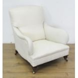 A Victorian Howard style Armchair the cushion back and shaped arms above a deep seat, raised on